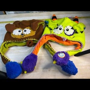 Pair of Flipeez kids ear flipping squeeze winter hats brown and green